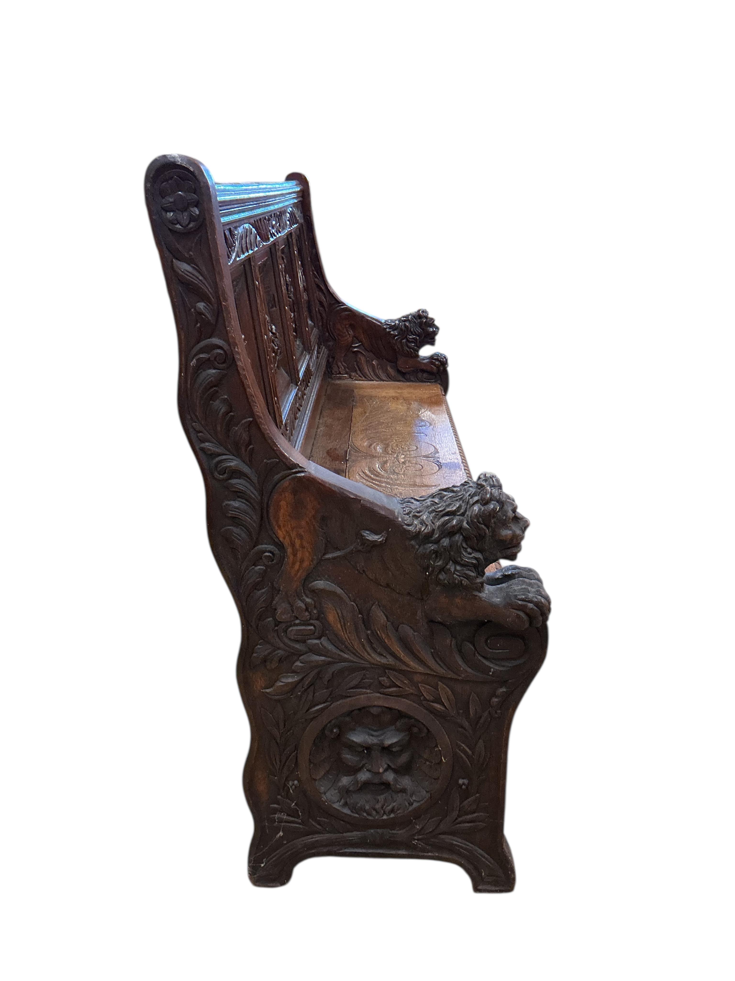 A late 19th century Flemish carved oak settle with hinged box seat, width 160cm, depth 42cm, height 106cm